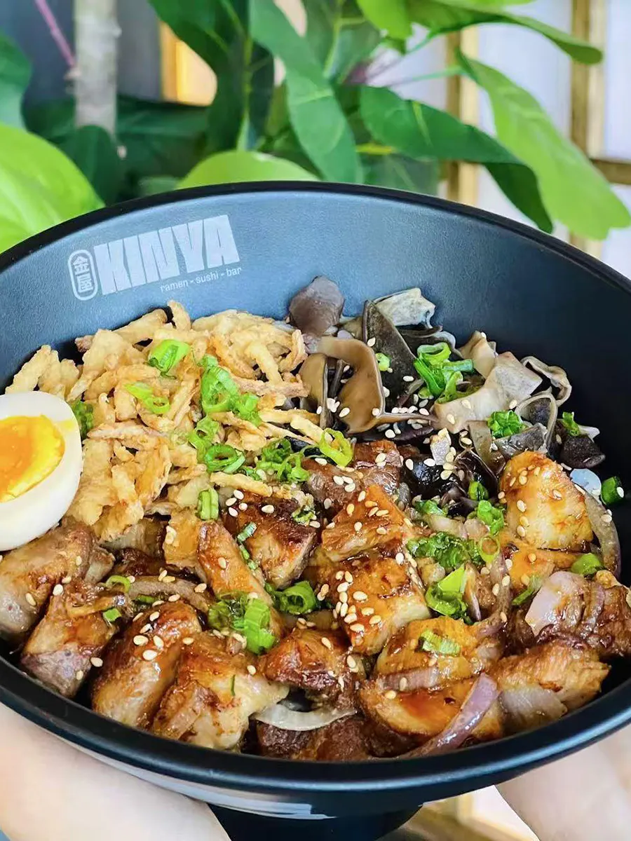 Sauteed chicken with black fungus, fried onions and soft boiled egg at Kinya, a Japanese Restaurant in Gainesville
