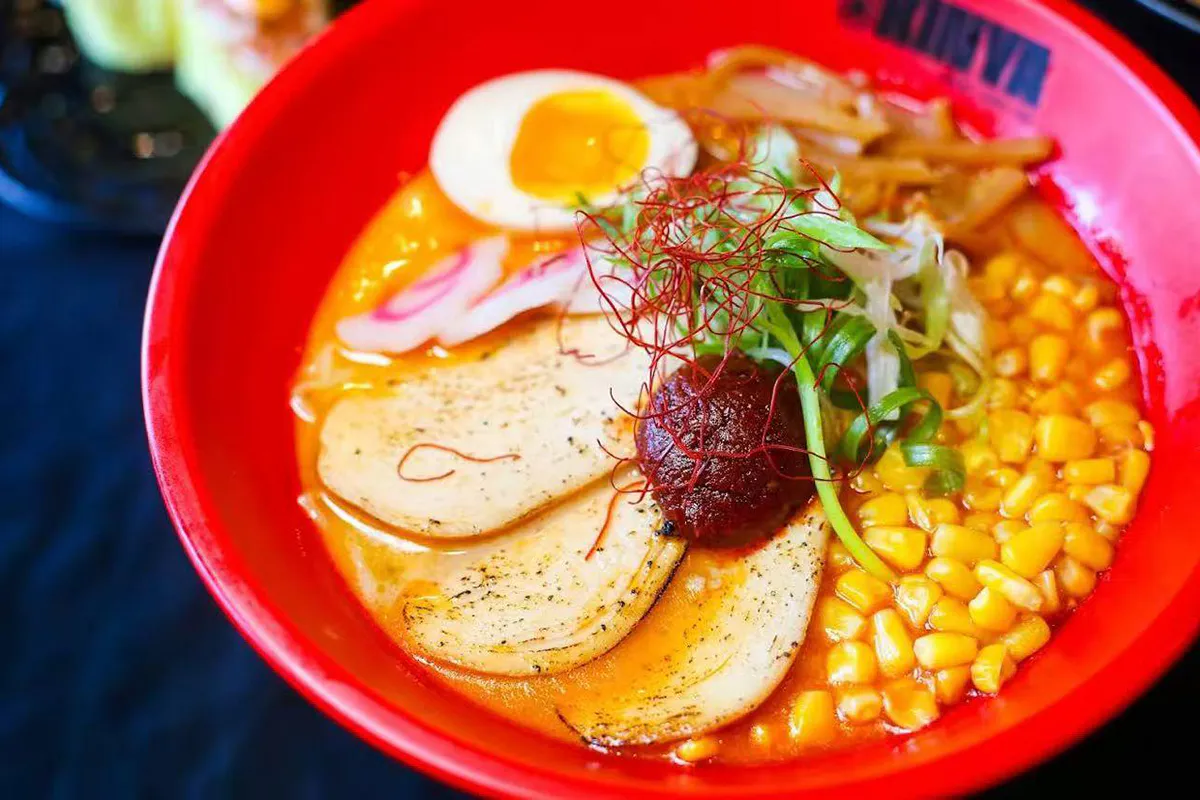 Spicy chicken broth with garlic paste, fish cake, sweet corn and boiled egg at Kinya, a Japanese Restaurant in Gainesville